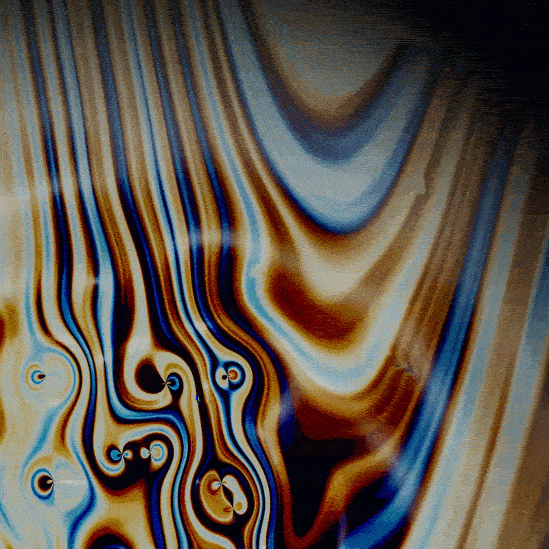 Shimmering orange, blue, white, and black stripes with a ripple effect